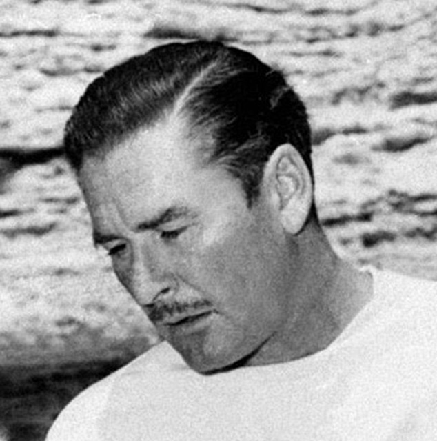US Actor Errol Flynn pays attention as he is given