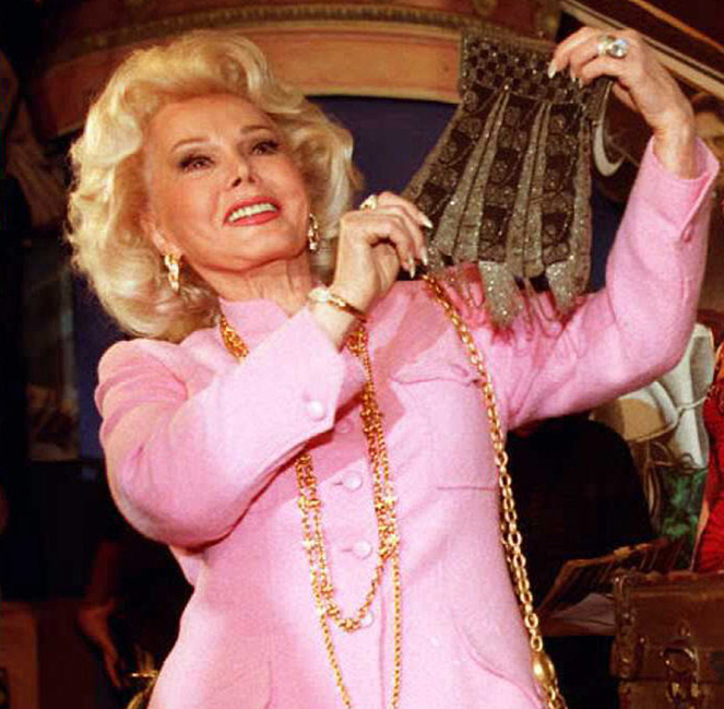 Actress Zsa Zsa Gabor,(L), holds up a beaded purse