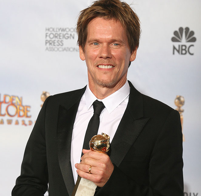 Kevin Bacon holds his award for best act