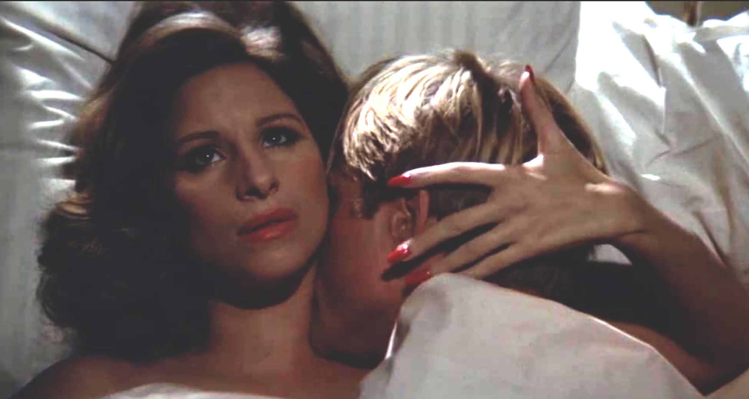 Robert Redford and Barbra Streisand as they lie in bed in a scene from the film “The Way We Were” (1973) 