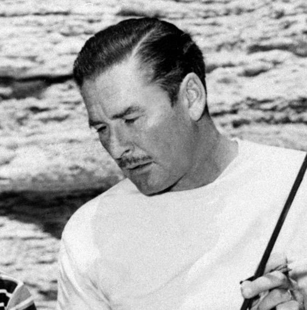 US Actor Errol Flynn pays attention as he is given