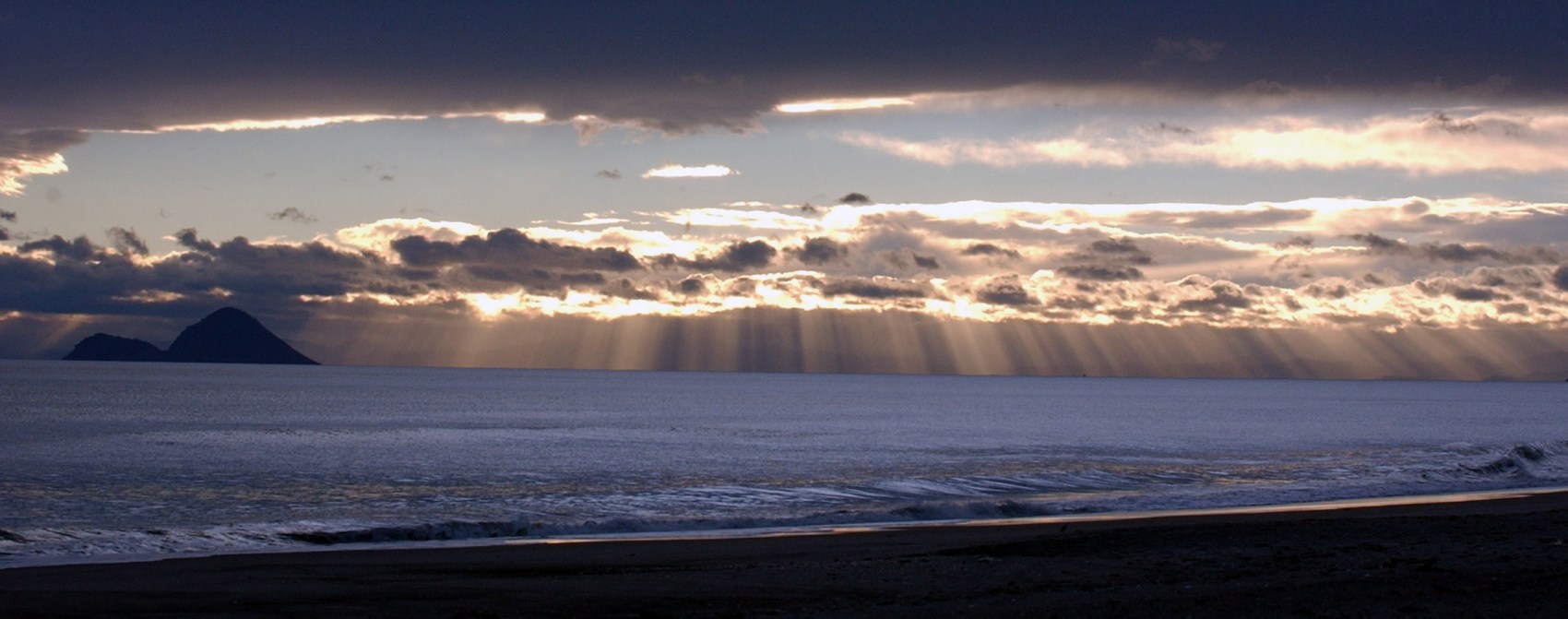 Early morning sunlight filters through clouds over